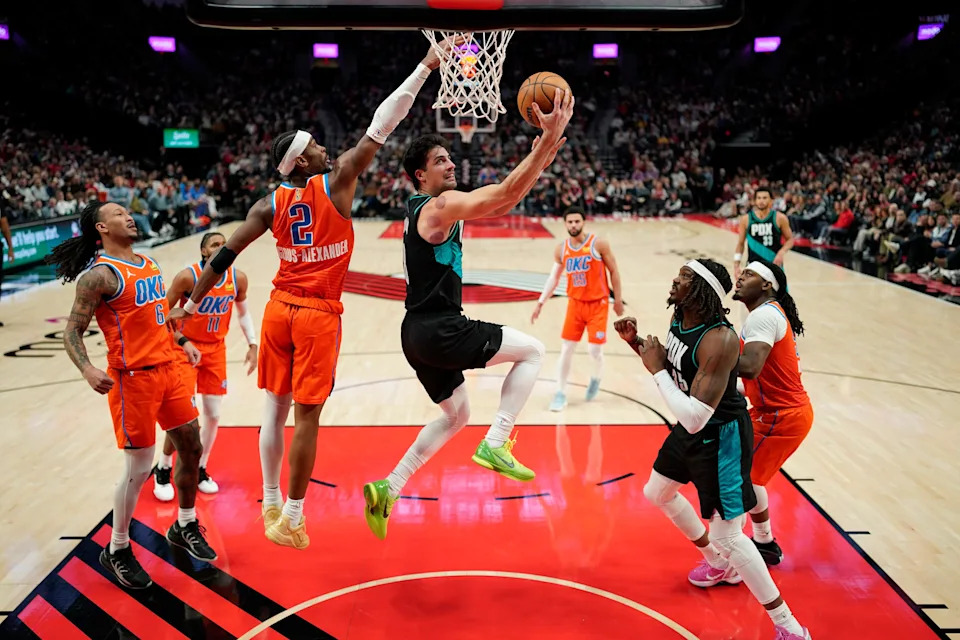 PORTLAND, OREGON - NOVEMBER 30: Deni Avdija #8 of the Portland Trail Blazers lays up a shot past Shai Gilgeous-Alexander #2 of the Oklahoma City Thunder during the second half at Moda Center on November 30, 2025 in Portland, Oregon. NOTE TO USER: User expressly acknowledges and agrees that, by downloading and or using this photograph, User is consenting to the terms and conditions of the Getty Images License Agreement. (Photo by Soobum Im/Getty Images)
