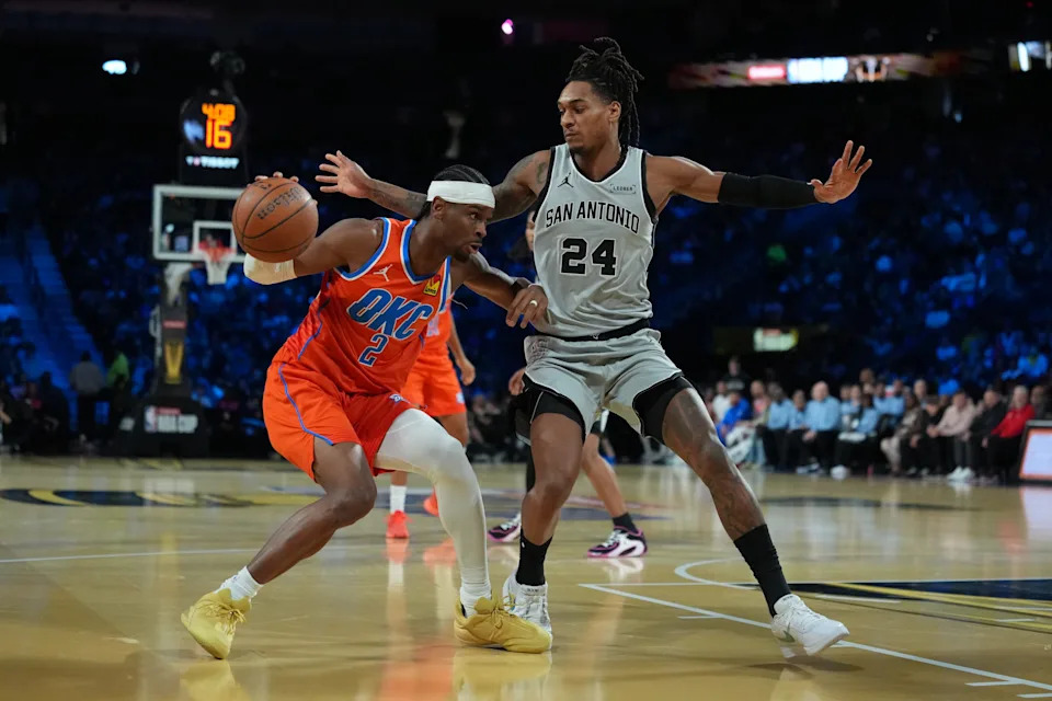 Dec 13, 2025; Las Vegas, Nevada, USA; Oklahoma City Thunder guard Shai Gilgeous-Alexander (2) is defends by San Antonio Spurs guard Devin Vassell (24) during the second quarter at T-Mobile Arena. Mandatory Credit: Kirby Lee-Imagn Images