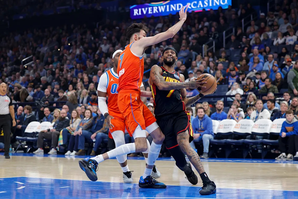 Dec 29, 2025; Oklahoma City, Oklahoma, USA; Atlanta Hawks guard Nickeil Alexander-Walker (7) drives to the basket as Oklahoma City Thunder center Chet Holmgren (7) defends during the first quarter at Paycom Center. Mandatory Credit: Alonzo Adams-Imagn Images