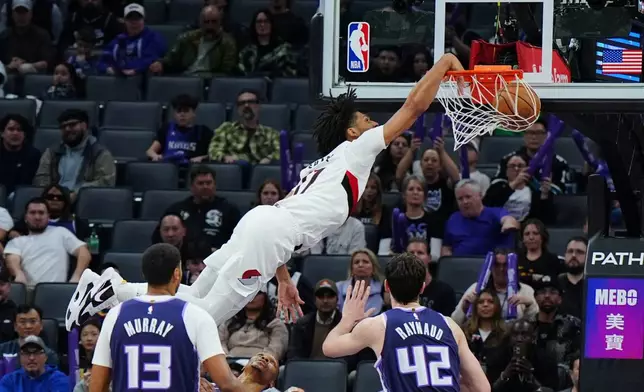 Portland Trail Blazers guard Shaedon Sharpe (17) dunks the ball during the second half of an NBA basketball game against the Sacramento Kings, Saturday, Dec. 20, 2025, in Sacramento, Calif. (AP Photo/Alan Greth)