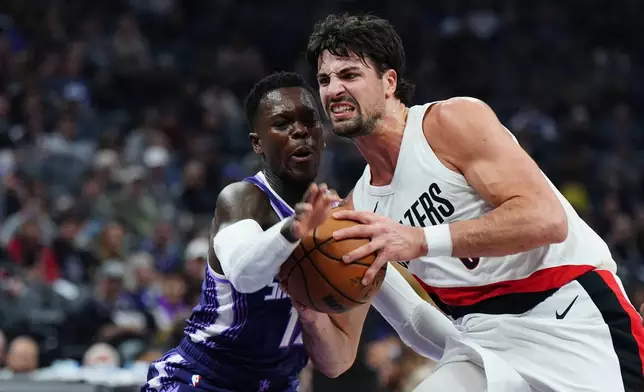 Portland Trail Blazers forward Deni Avdija (8) tries to drive past Sacramento Kings guard Dennis Schroder (17) during the first half of an NBA basketball game Saturday, Dec. 20, 2025, in Sacramento, Calif. (AP Photo/Alan Greth)