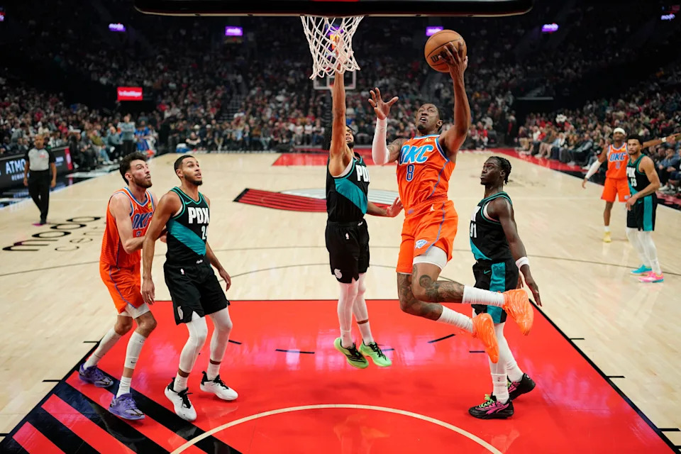 PORTLAND, OREGON - NOVEMBER 30: Jalen Williams #8 of the Oklahoma City Thunder lays up a shot against Shaedon Sharpe #17 of the Portland Trail Blazers during the first half at Moda Center on November 30, 2025 in Portland, Oregon. NOTE TO USER: User expressly acknowledges and agrees that, by downloading and or using this photograph, User is consenting to the terms and conditions of the Getty Images License Agreement. (Photo by Soobum Im/Getty Images)