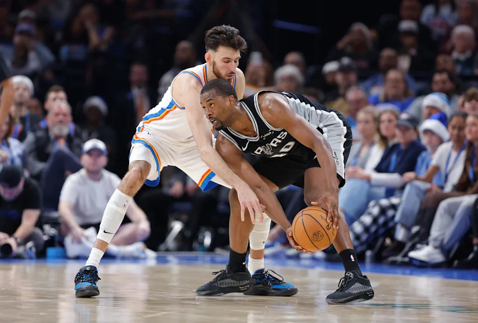 Dec 25, 2025; Oklahoma City, Oklahoma, USA; San Antonio Spurs forward Harrison Barnes (40) moves the ball as Oklahoma City Thunder center Chet Holmgren (7) defends during the second half at Paycom Center. Mandatory Credit: Alonzo Adams-Imagn Images