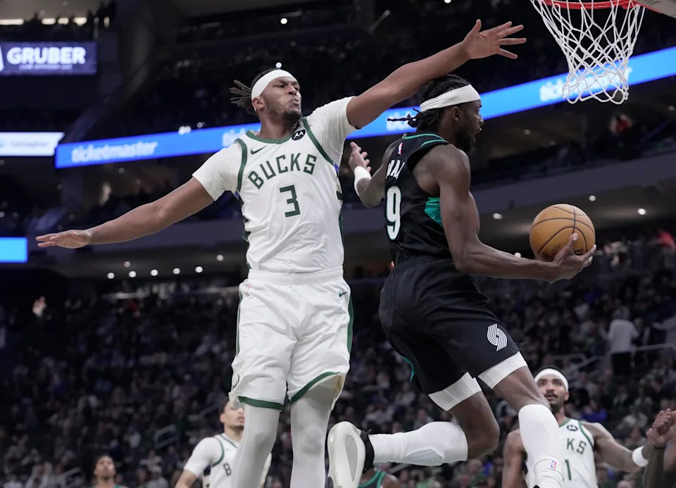 Milwaukee Bucks center Myles Turner (3) fouls Portland Trail Blazers forward Jerami Grant (9) during the first half their game Monday, November 24, 2025 at Fiserv Forum in Milwaukee, Wisconsin.