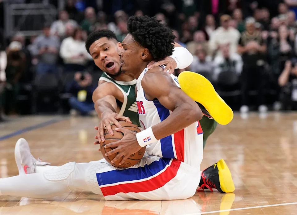 Milwaukee Bucks forward Giannis Antetokounmpo battles for possession of the ball with Detroit Pistons guard Ausar Thompson in the first half at Fiserv Forum on Wednesday, Dec. 3 in Milwaukee, Wisconsin.