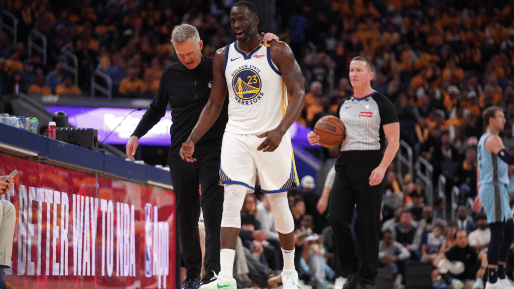 Golden State Warriors guard Stephen Curry (center) is flanked by head coach Steve Kerr and forward Draymond Green as he is presented his gold medal for his performance for Team USA at the 2024 Summer Olympics in Paris before taking on the Sacramento Kings at Chase Center.