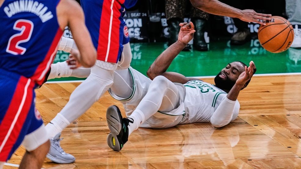 Boston Celtics guard Jaylen Brown is knocked to the floor by Detroit Pistons guard Ausar Thompson, top, during the second half of an NBA basketball game, Monday, Dec. 15, 2025, in Boston. (AP Photo/Charles Krupa)