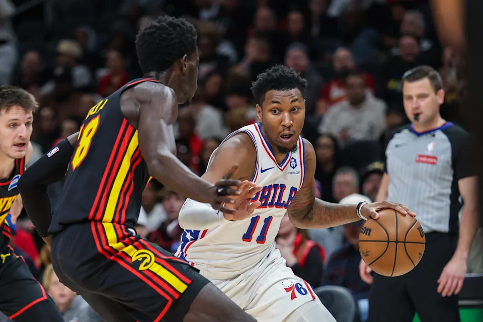 Dec 14, 2025; Atlanta, Georgia, USA; Philadelphia 76ers forward Justin Edwards (11) drives to the basket against Atlanta Hawks forward Mouhamed Gueye (18) during the first quarter at State Farm Arena. Mandatory Credit: Jordan Godfree-Imagn Images