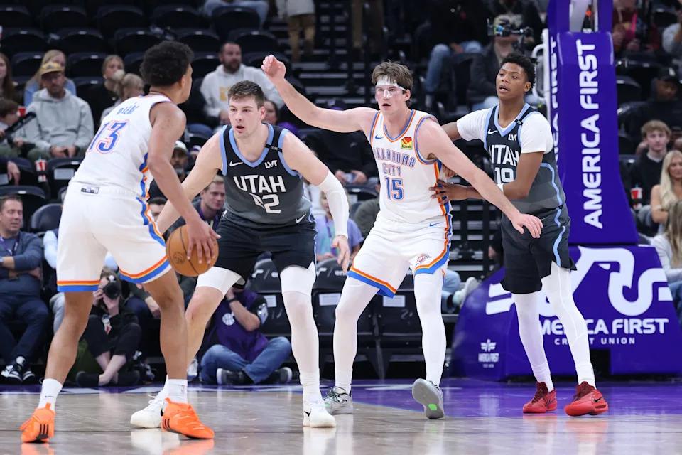 Dec 7, 2025; Salt Lake City, Utah, USA; Oklahoma City Thunder center Branden Carlson (15) looks for a pass to the post by forward Ousmane Dieng (13) as Utah Jazz forward Kyle Filipowski (22) and guard Ace Bailey (19) defend during the second half at Delta Center. Mandatory Credit: Rob Gray-Imagn Images