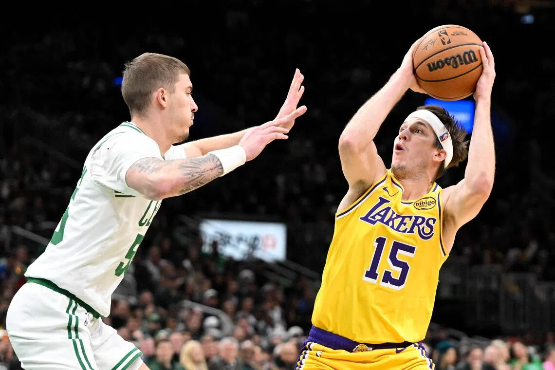 Austin Reaves of the Los Angeles Lakers attempts a shot past Baylor Scheierman of the Boston Celtics during the first half at the TD Garden.
