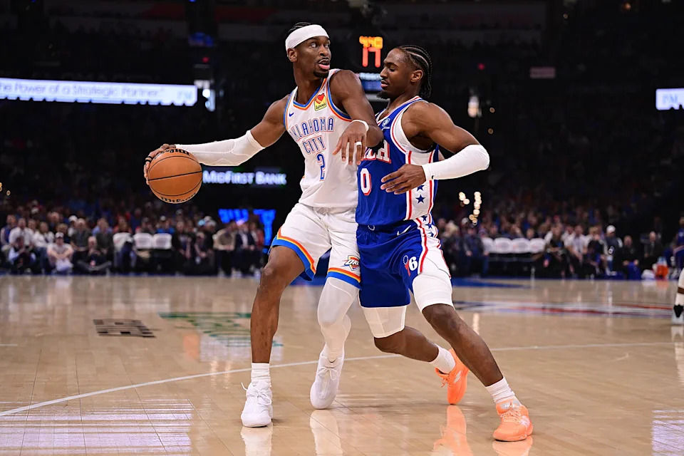 OKLAHOMA CITY, OKLAHOMA - DECEMBER 28: Shai Gilgeous-Alexander #2 of the Oklahoma City Thunder handles the ball while being defended by Tyrese Maxey #0 of the Philadelphia 76ers during the first half at Paycom Center on December 28, 2025 in Oklahoma City, Oklahoma. NOTE TO USER: User expressly acknowledges and agrees that, by downloading and or using this photograph, User is consenting to the terms and conditions of the Getty Images License Agreement. (Photo by Joshua Gateley/Getty Images)