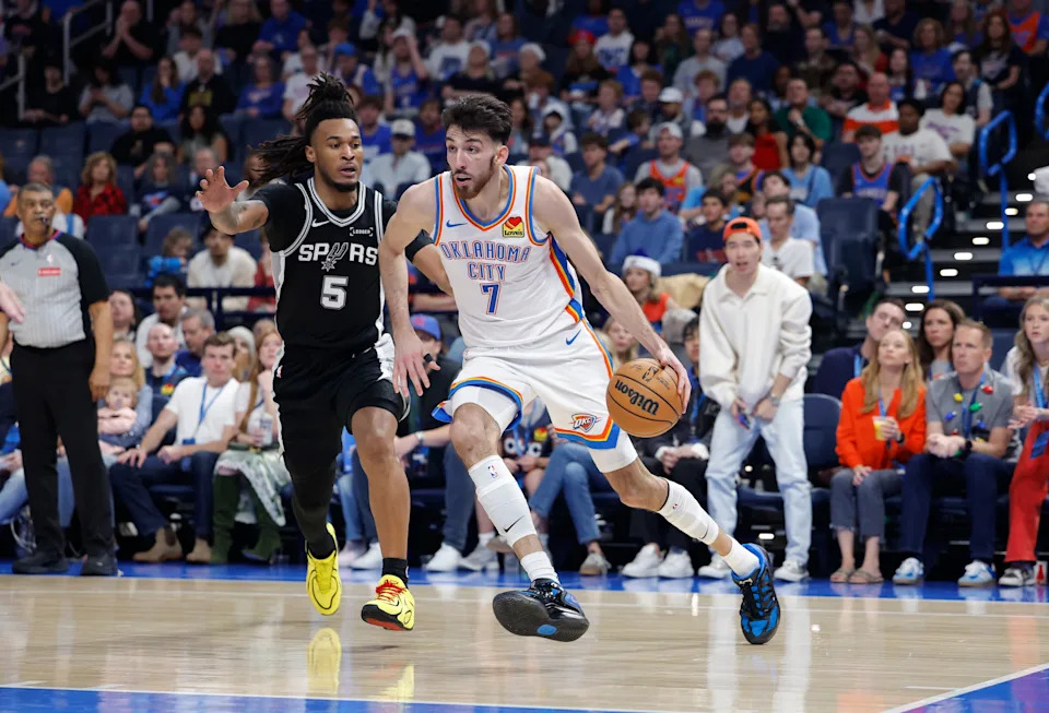 Dec 25, 2025; Oklahoma City, Oklahoma, USA; Oklahoma City Thunder center Chet Holmgren (7) drives to the basket beside San Antonio Spurs guard Stephon Castle (5) during the second half at Paycom Center. Mandatory Credit: Alonzo Adams-Imagn Images