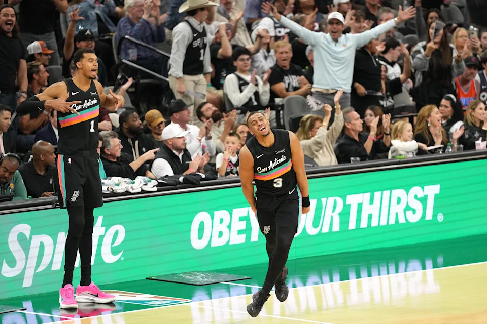 Dec 23, 2025; San Antonio, Texas, USA; San Antonio Spurs forwards Keldon Johnson (3) and Victor Wembanyama (1) react after Johnson scored a three point basket during the second half at Frost Bank Center. Mandatory Credit: Scott Wachter-Imagn Images