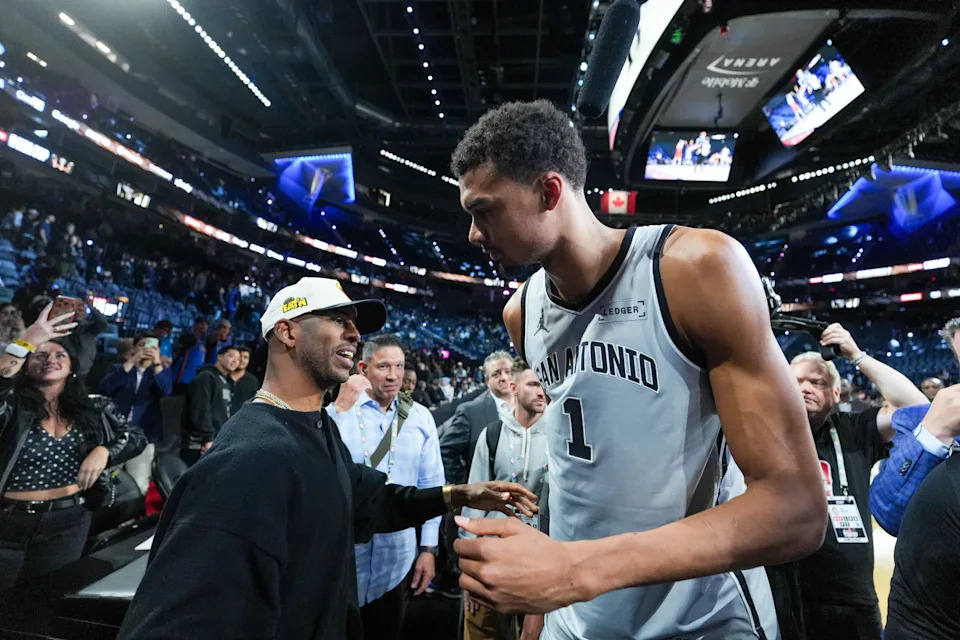 Dec 13, 2025; Las Vegas, Nevada, USA; San Antonio Spurs forward Victor Wembanyama (1) celebrates with Chris Paul after the game against the Oklahoma City Thunder at T-Mobile Arena. Mandatory Credit: Kirby Lee-Imagn Images