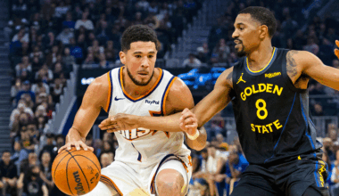 Golden State Warriors guard De'Anthony Melton (8) defends Phoenix Suns guard Devin Booker (1) during the first quarter at Chase Center.