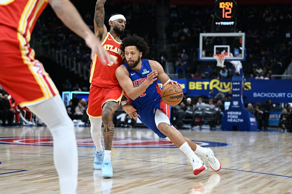 Detroit Pistons guard Cade Cunningham (2) drives past Atlanta Hawks guard Nickeil Alexander-Walker (7) in the first quarter at Little Caesars Arena in Detroit on Friday, Dec. 12, 2025.