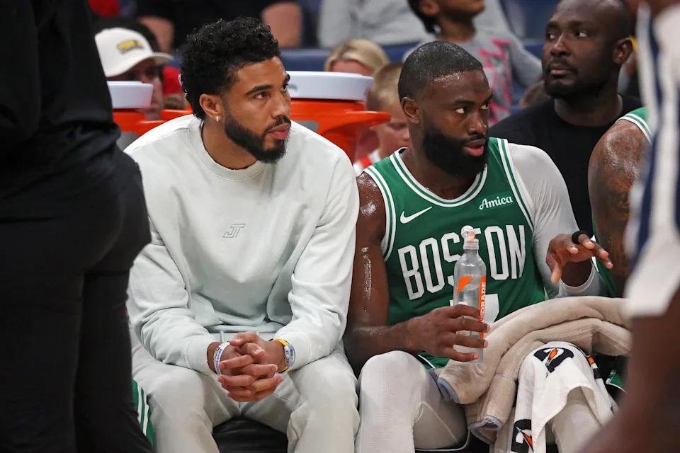 Oct 8, 2025; Memphis, Tennessee, USA; Boston Celtics forward Jayson Tatum (0) and guard Jaylen Brown (7) look on from the bench during the second quarter against the Memphis Grizzlies at FedExForum. Mandatory Credit: Petre Thomas-Imagn Images