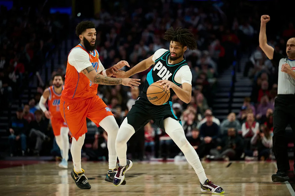 Nov 30, 2025; Portland, Oregon, USA; Portland Trail Blazers guard Shaedon Sharpe (17) dribbles the ball during the second half as he is fouled by Oklahoma City Thunder guard Kenrich Williams (34) at Moda Center. Mandatory Credit: Troy Wayrynen-Imagn Images