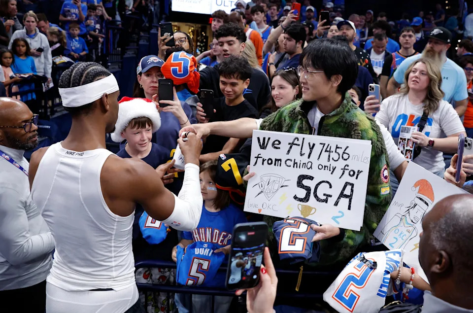 Dec 25, 2025; Oklahoma City, Oklahoma, USA; Oklahoma City Thunder guard Shai Gilgeous-Alexander signs autographs for fans before a game against the San Antonio Spurs at Paycom Center. Mandatory Credit: Alonzo Adams-Imagn Images