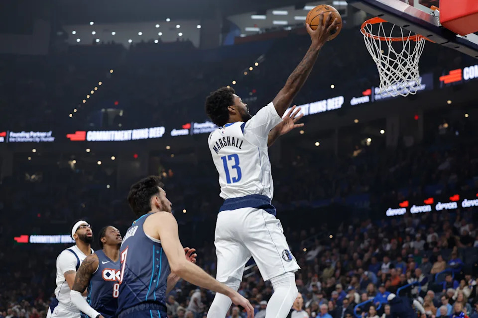 Dec 5, 2025; Oklahoma City, Oklahoma, USA; Dallas Mavericks forward Naji Marshall (13) goes to the basket in front of Oklahoma City Thunder center Chet Holmgren (7) during the first quarter at Paycom Center. Mandatory Credit: Alonzo Adams-Imagn Images