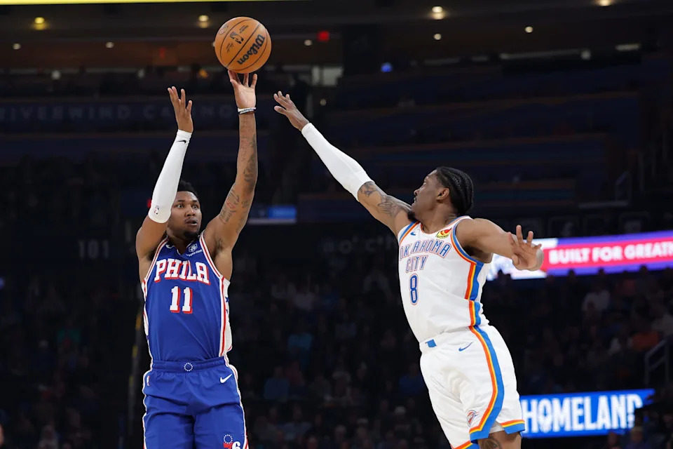 Dec 28, 2025; Oklahoma City, Oklahoma, USA; Philadelphia 76ers forward Justin Edwards (11) shoots as Oklahoma City Thunder guard Jalen Williams (8) defends during the second quarter at Paycom Center. Mandatory Credit: Alonzo Adams-Imagn Images