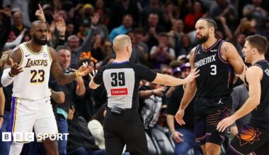 An official comes between Lebron James and Dillon Brooks