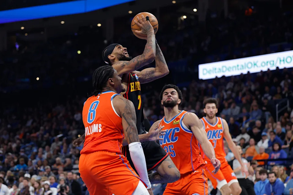 Dec 29, 2025; Oklahoma City, Oklahoma, USA; Atlanta Hawks guard Nickeil Alexander-Walker (7) goes up for a basket between Oklahoma City Thunder guard Jalen Williams (8) and guard Ajay Mitchell (25) during the first half at Paycom Center. Mandatory Credit: Alonzo Adams-Imagn Images