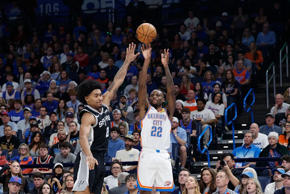 Dec 25, 2025; Oklahoma City, Oklahoma, USA; Oklahoma City Thunder guard Cason Wallace (22) shoots as San Antonio Spurs guard Dylan Harper (2) defends during the second half at Paycom Center. Mandatory Credit: Alonzo Adams-Imagn Images