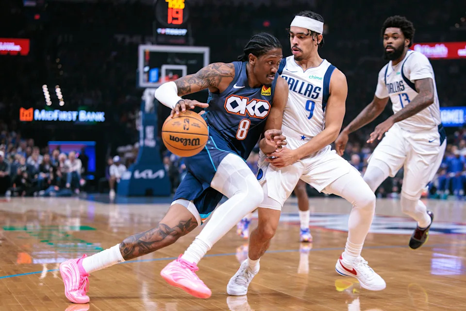OKLAHOMA CITY, OKLAHOMA - DECEMBER 05: Jalen Williams #8 of the Oklahoma City Thunder drives to the basket around Ryan Nembhard #9 of the Dallas Mavericks during the first half at Paycom Center on December 5, 2025 in Oklahoma City, Oklahoma. NOTE TO USER: User expressly acknowledges and agrees that, by downloading and or using this photograph, User is consenting to the terms and conditions of the Getty Images License Agreement. (Photo by William Purnell/Getty Images)