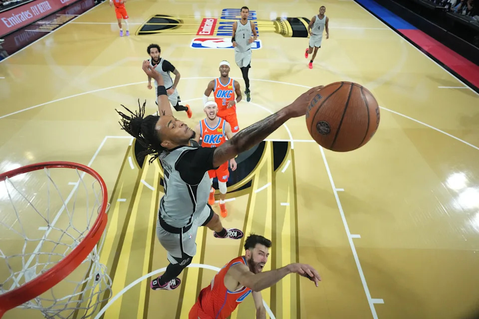 Dec 13, 2025; Las Vegas, Nevada, USA; San Antonio Spurs guard Stephon Castle (5) blocks the shot attempt by Oklahoma City Thunder center Chet Holmgren (7) during the second half at T-Mobile Arena. Mandatory Credit: Kirby Lee-Imagn Images