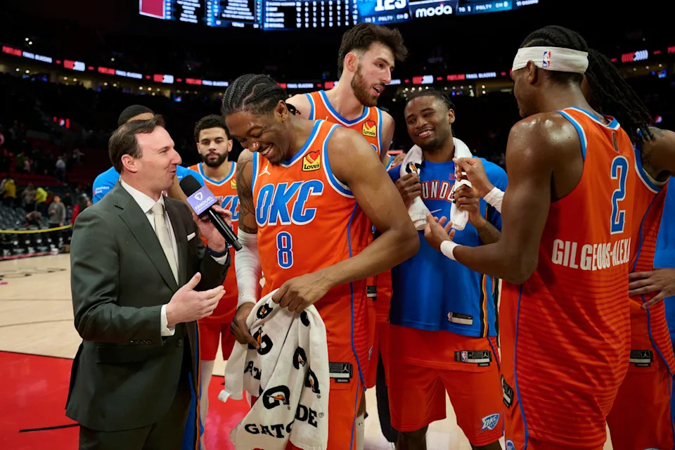 Nov 30, 2025; Portland, Oregon, USA; Oklahoma City Thunder guard Jalen Williams (8) laughs during a post-game interview with teammates after a game against the Portland Trail Blazers at Moda Center. Mandatory Credit: Troy Wayrynen-Imagn Images