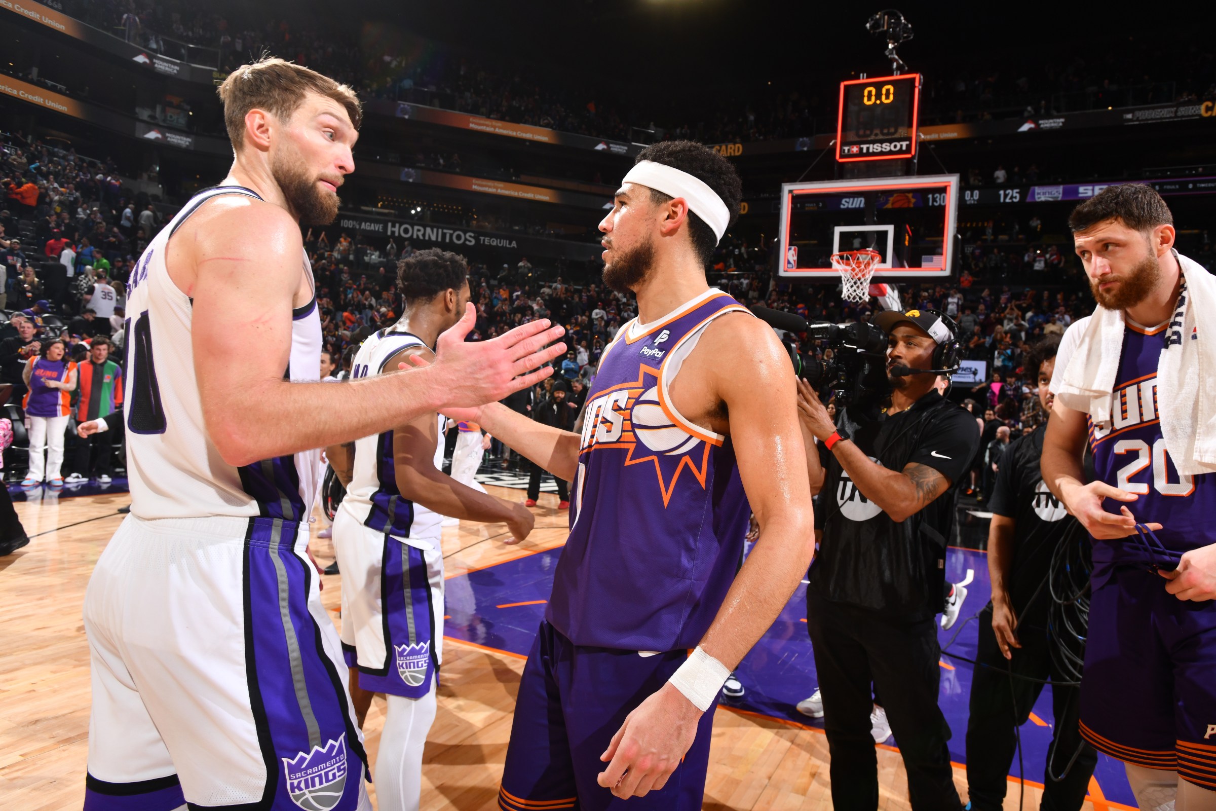PHOENIX, AZ - FEBRUARY 13: Domantas Sabonis #10 of the Sacramento Kings embraces Devin Booker #1 of the Phoenix Suns after the game on February 13, 2024 at Footprint Center in Phoenix, Arizona. NOTE TO USER: User expressly acknowledges and agrees that, by downloading and or using this photograph, user is consenting to the terms and conditions of the Getty Images License Agreement. Mandatory Copyright Notice: Copyright 2024 NBAE (Photo by Barry Gossage/NBAE via Getty Images)