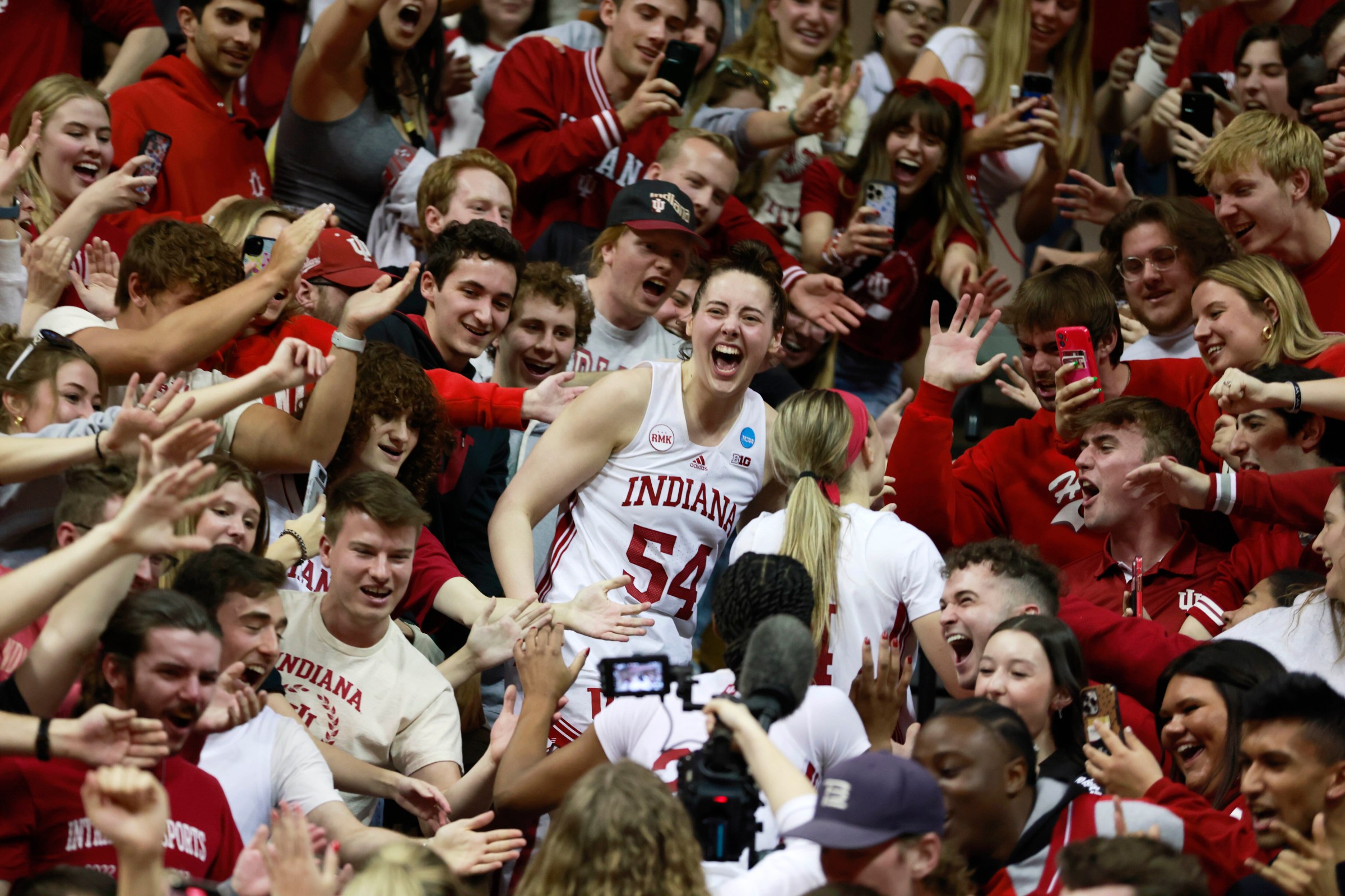 BLOOMINGTON, INDIANA, UNITED STATES - 2024/03/25: Indiana University’s Mackenzie Holmes (54) celebrates with fans after the Hoosiers beat Oklahoma University 75-68 to advance to the Sweet Sixteen during the NCAA women’s basketball tournament game at Simon Skjodt Assembly Hall. The Hoosiers defeated Oklahoma University 75-68 to advance to the Sweet Sixteen. (Photo by Jeremy Hogan/SOPA Images/LightRocket via Getty Images)