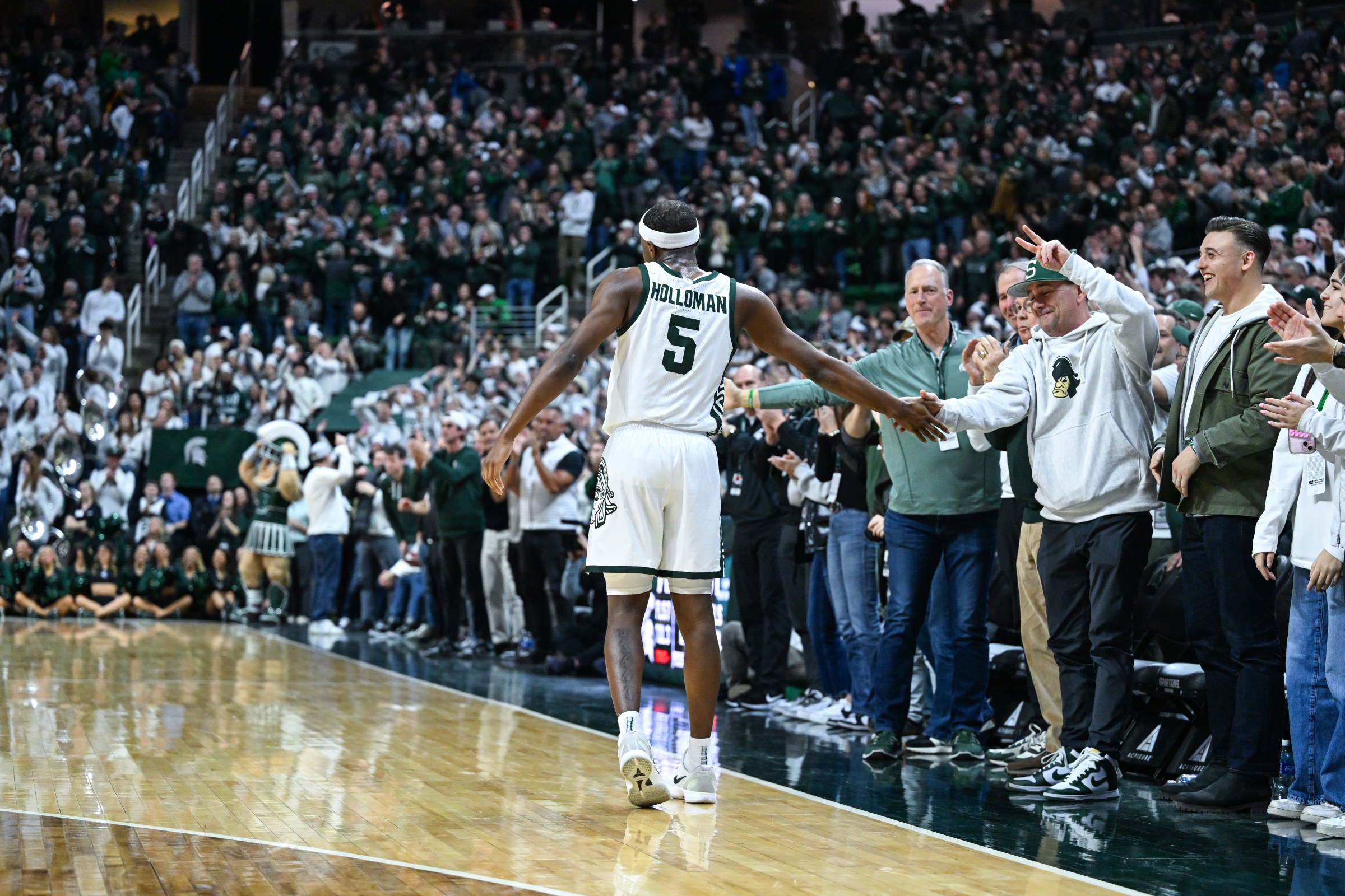 EAST LANSING, MI - FEBRUARY 18: Michigan State Spartans guard Tre Holloman (5) celebrates with fans during a college basketball game between the Michigan State Spartans and Purdue Boilermakers on February 18, 2025 at the Breslin Center in East Lansing, MI. (Photo by Adam Ruff/Icon Sportswire via Getty Images)