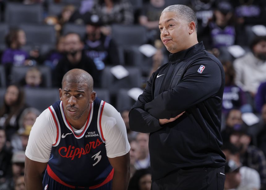 Clippers head coach Tyronn Lue, right, stands next to Paul during a preseason game in October.