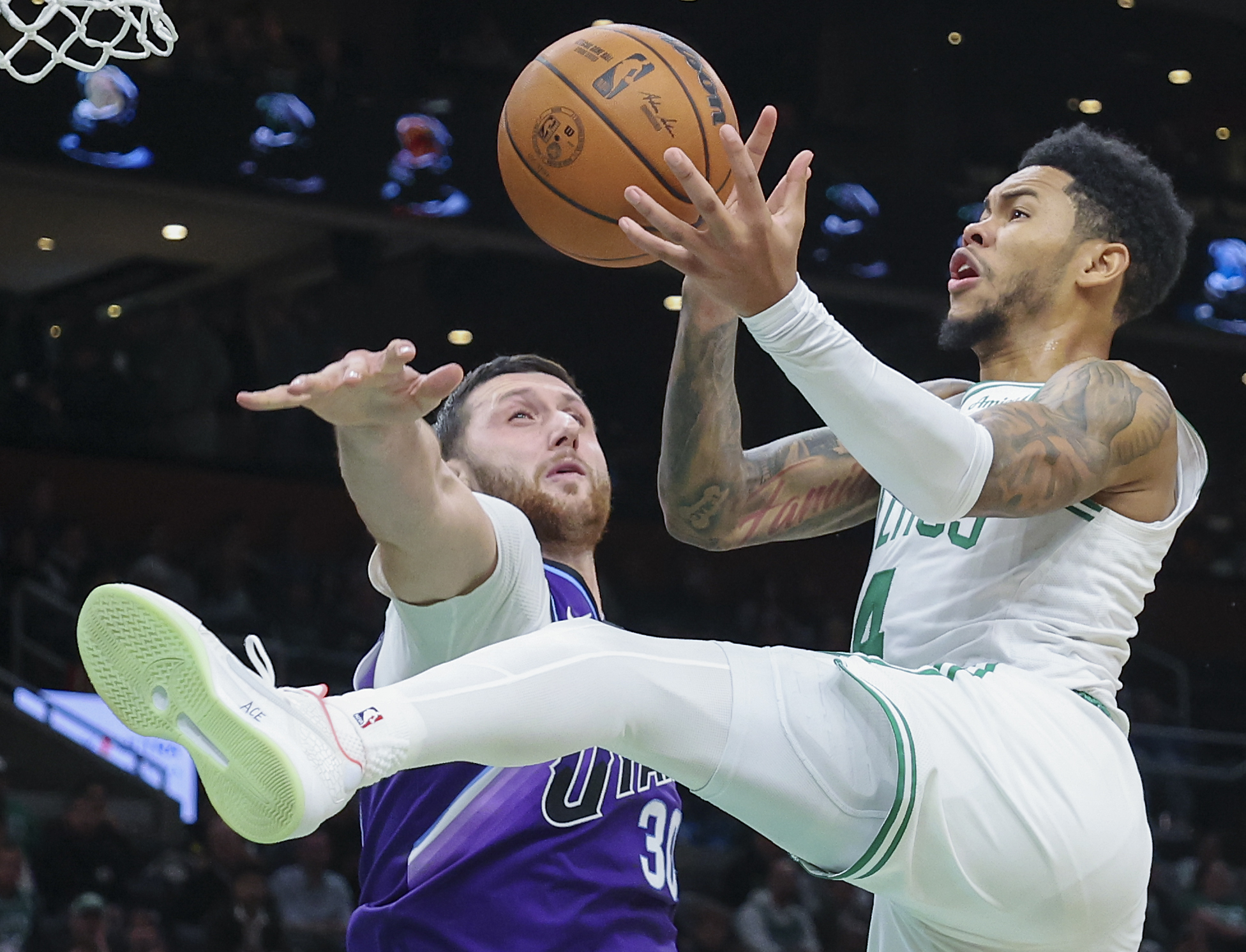 Boston, MA - November 3: Boston Celtics guard Anfernee Simons drives to the basket and is fouled by Utah Jazz center Jusuf Nurki in the fourth quarter at TD Garden on November 3, 2025. (Photo by Matthew J. Lee/The Boston Globe via Getty Images)