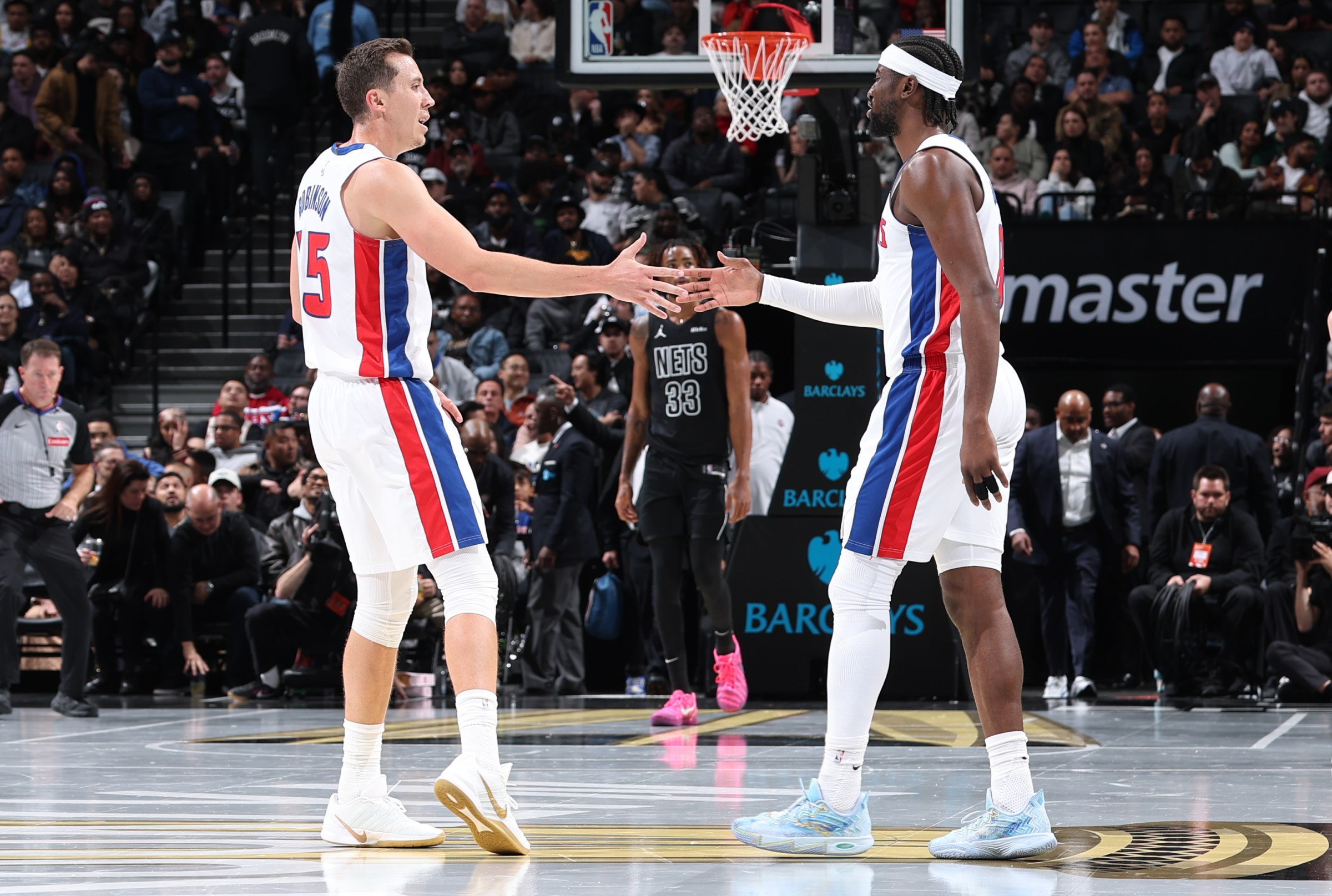 NEW YORK, NY - NOVEMBER 7: Duncan Robinson #55 and Caris LeVert #8 of the Detroit Pistons high fives against the Brooklyn Nets during the 2025-26 Emirates Cup on November 7, 2025 at Madison Square Garden in New York City, New York. NOTE TO USER: User expressly acknowledges and agrees that, by downloading and or using this photograph, User is consenting to the terms and conditions of the Getty Images License Agreement. Mandatory Copyright Notice: Copyright 2025 NBAE (Photo by David L. Nemec/NBAE via Getty Images)
