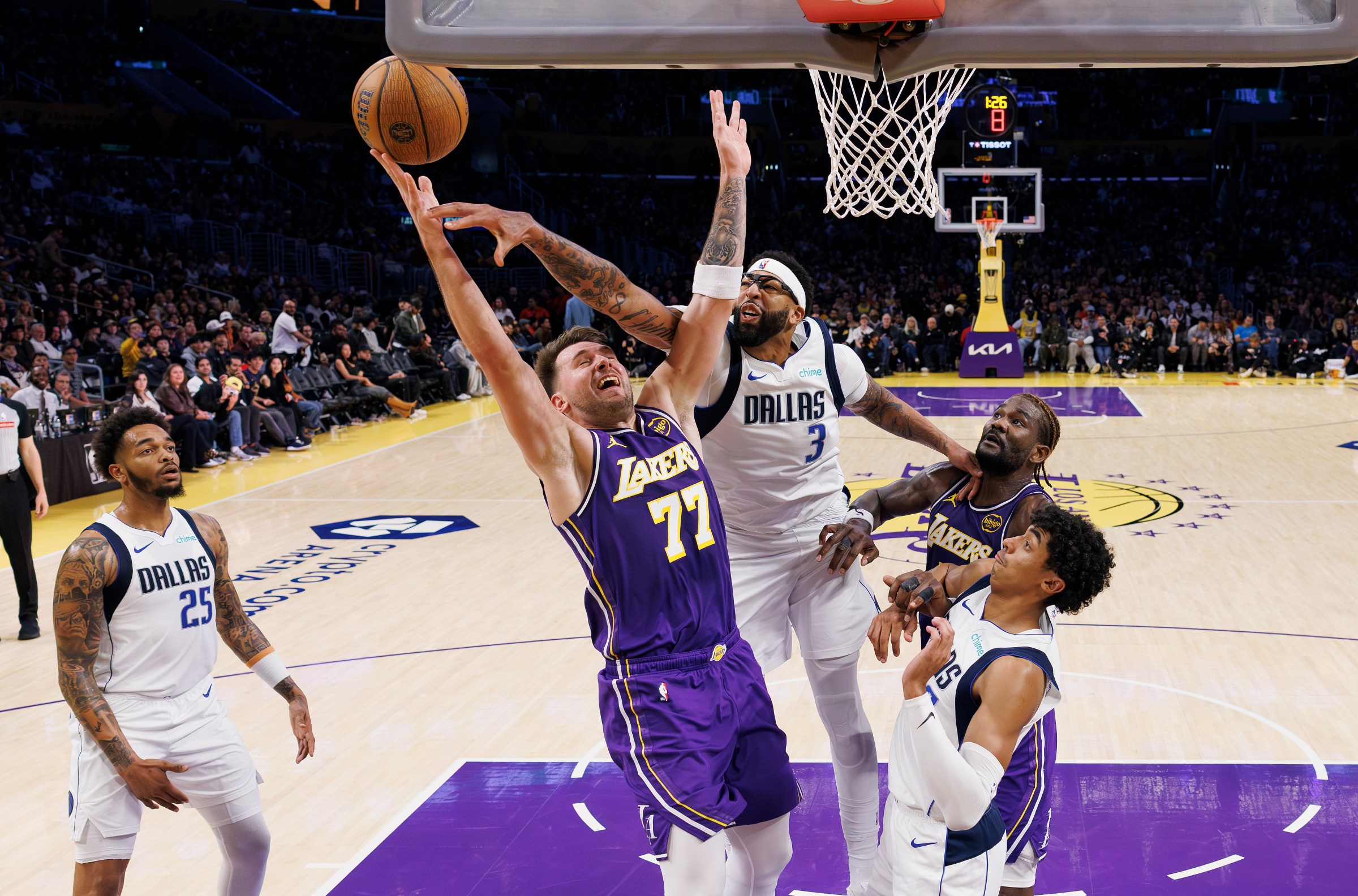 LOS ANGELES, CA - NOVEMBER 28, 2025: Los Angeles Lakers guard Luka Doncic (77) is fouled by Dallas Mavericks forward Anthony Davis (3) driving to the basket in the second half at Crypto.com Arena on November 28, 2025 in Los Angeles, California.(Gina Ferazzi / Los Angeles Times via Getty Images)