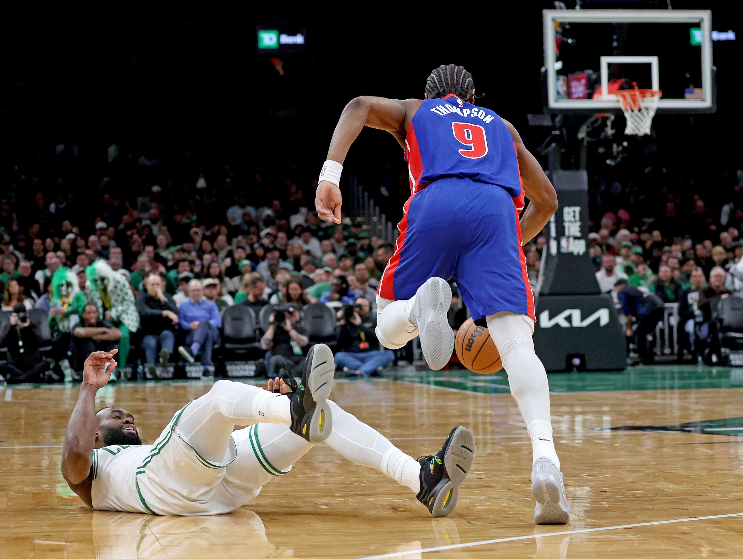 Boston, MA - December 15 - Boston Celtics guard Jaylen Brown (7) goes down as Detroit Pistons guard Ausar Thompson (9) takes the ball down court during the second half of a NBA game. (Photo By Matt Stone/MediaNews Group/Boston Herald via Getty Images).