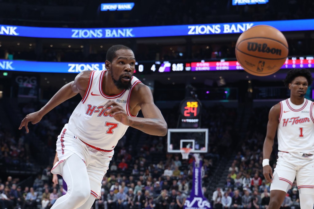 Houston Rockets forward Kevin Durant (7) chases after the ball during the first half of an NBA game.