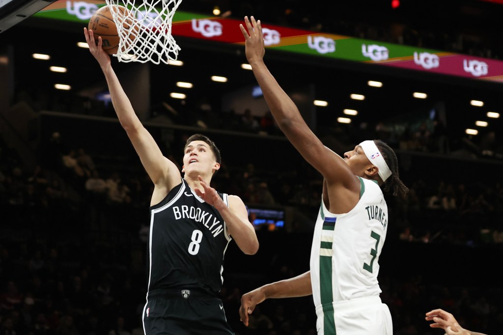 Brooklyn Nets guard Egor Demin (8) goes to the basket past Milwaukee Bucks center Myles Turner (3) during the first half of an NBA basketball game, Sunday, Dec. 14, 2025, in New York.