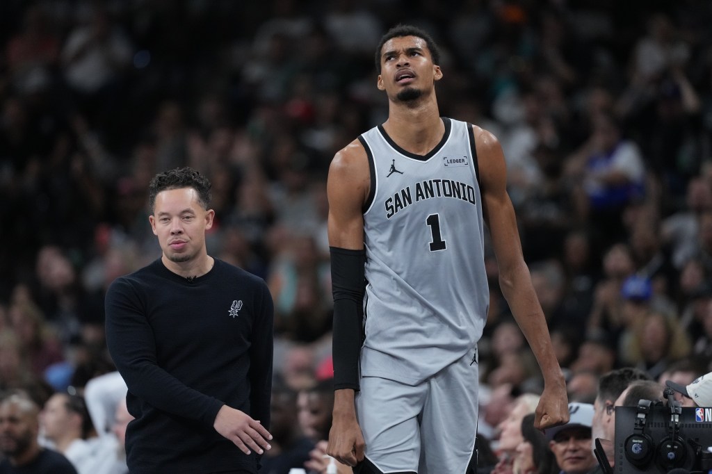 San Antonio Spurs forward Victor Wembanyama (1) and head coach Mitch Johnson.