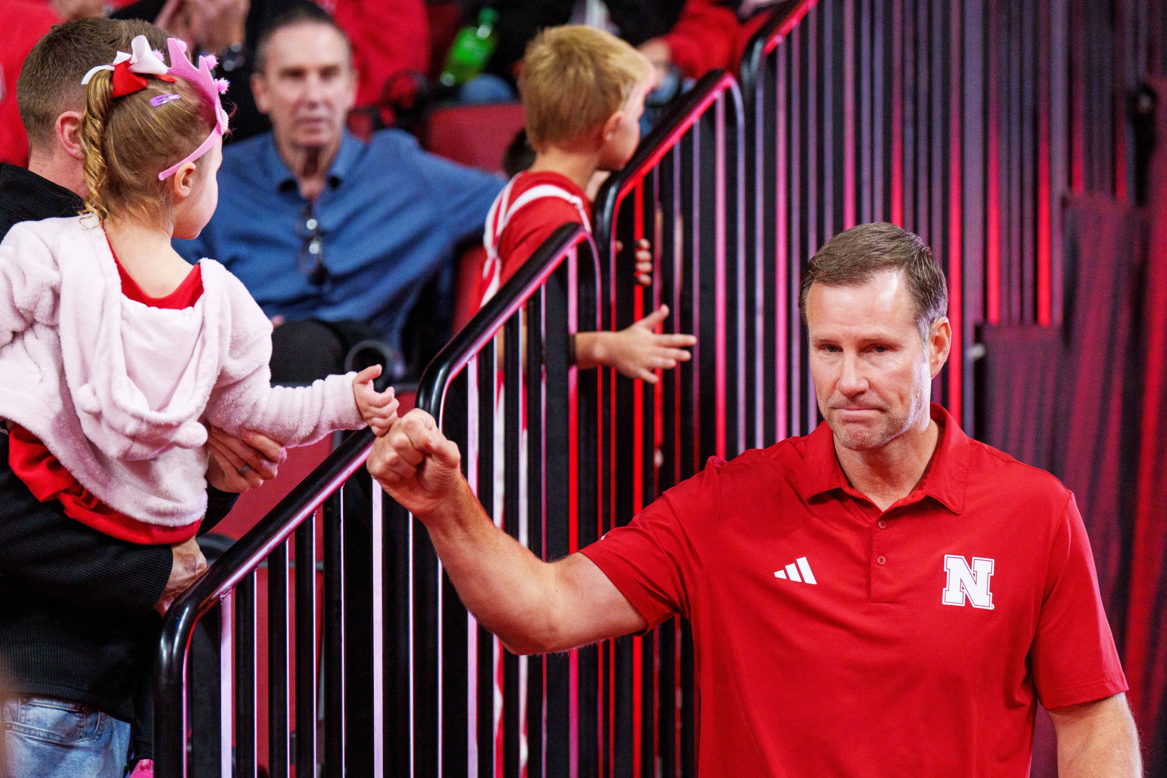 Nov 8, 2025; Lincoln, Nebraska, USA; Nebraska Cornhuskers head coach Fred Hoiberg fist bumps a young fan as he walks onto the court before the game against the Florida International Panthers at Pinnacle Bank Arena. Mandatory Credit: Dylan Widger-Imagn Images