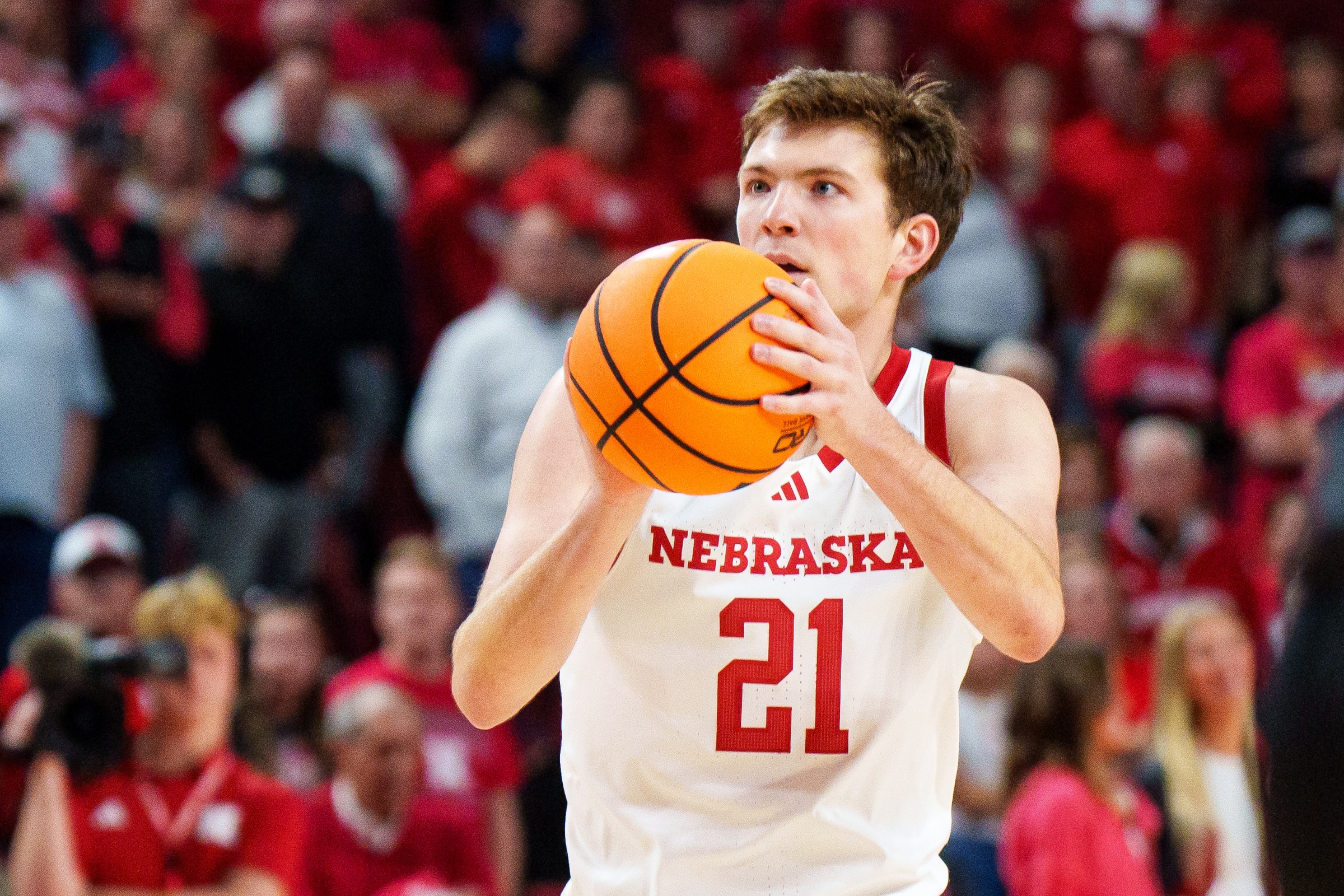 Nov 11, 2025; Lincoln, Nebraska, USA; Nebraska Cornhuskers forward Pryce Sandfort (21) shoots a three point basket against the Maryland Eastern Shore Hawks during the first half at Pinnacle Bank Arena. Mandatory Credit: Dylan Widger-Imagn Images