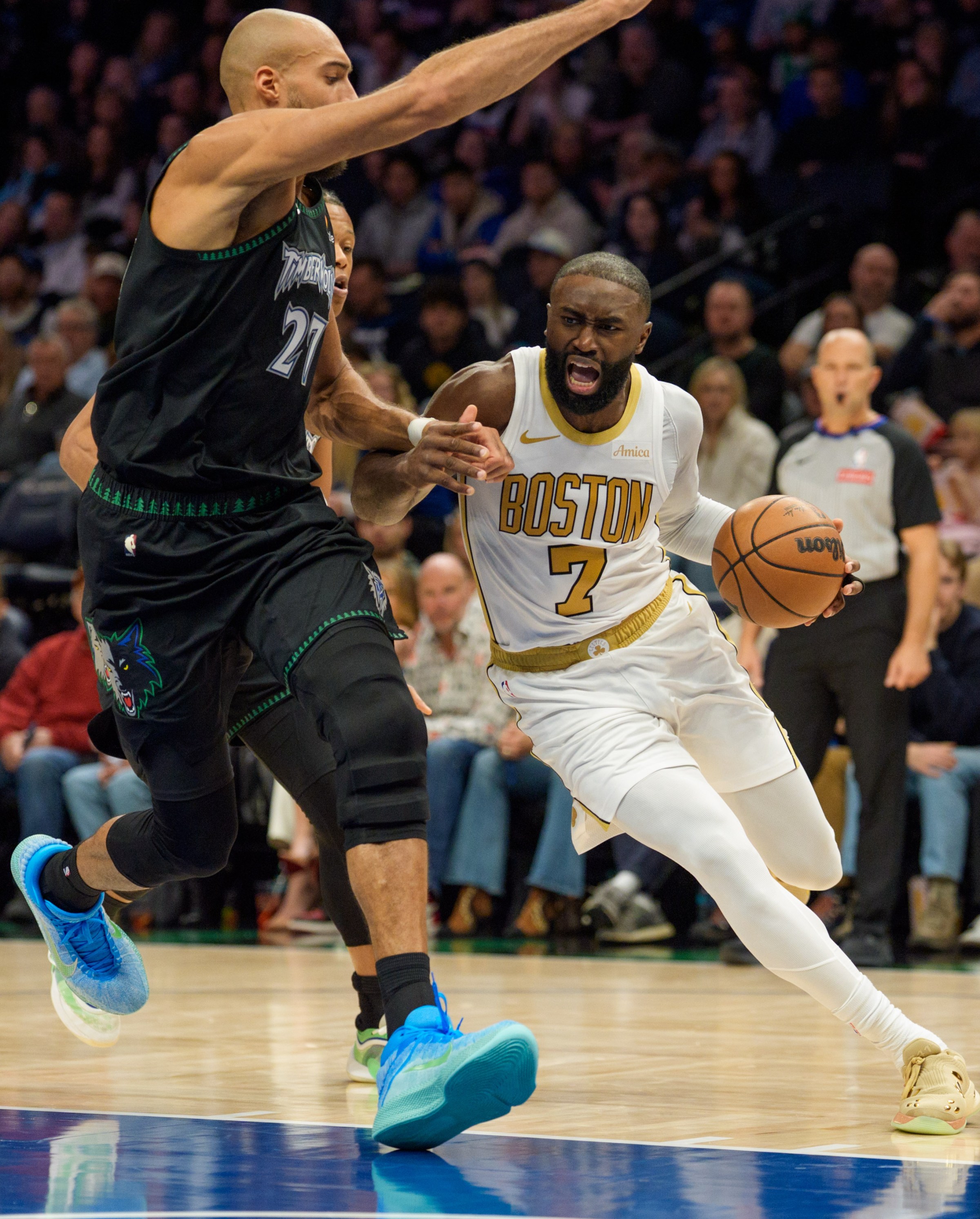 Nov 29, 2025; Minneapolis, Minnesota, USA; Boston Celtics guard Jaylen Brown (7) drives against Minnesota Timberwolves center Rudy Gobert (27) in the second quarter at Target Center. Mandatory Credit: Matt Blewett-Imagn Images