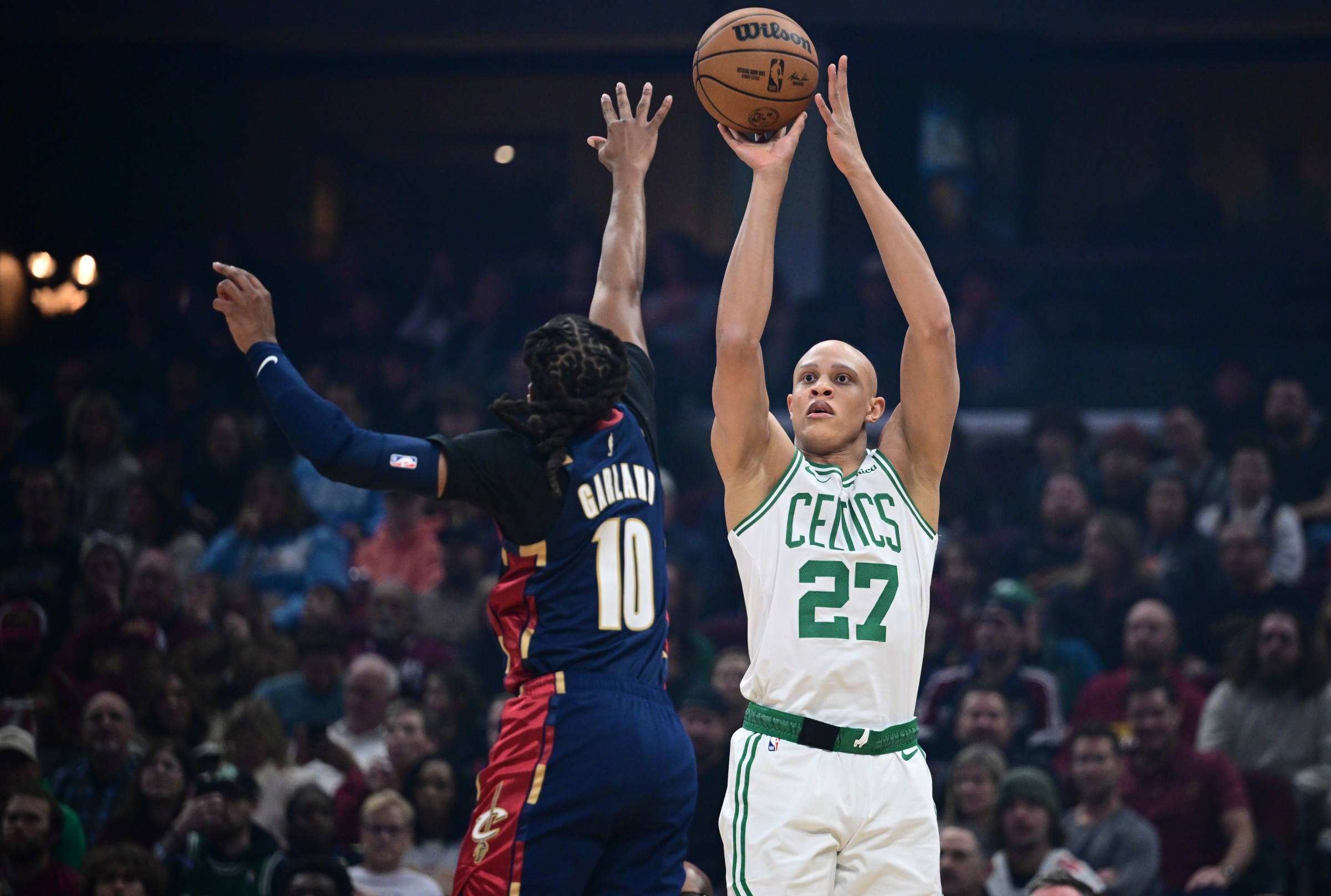 Nov 30, 2025; Cleveland, Ohio, USA; Boston Celtics guard Jordan Walsh (27) shoots a three point shot over Cleveland Cavaliers guard Darius Garland (10) during the first half at Rocket Arena. Mandatory Credit: David Dermer-Imagn Images