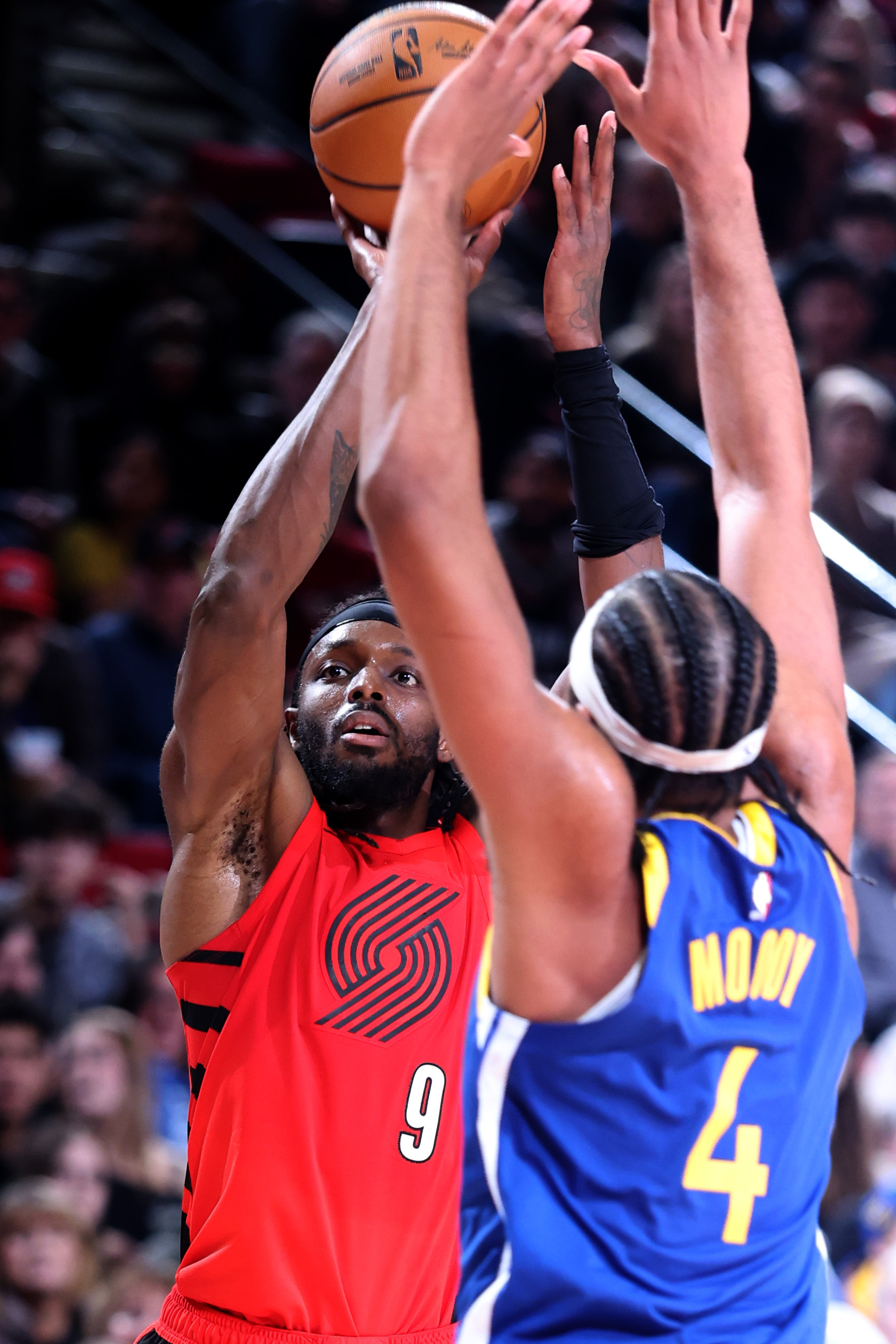 Dec 14, 2025; Portland, Oregon, USA; Portland Trail Blazers forward Jerami Grant (9) shoots a three-point shot against Golden State Warriors guard Moses Moody (4) during the second half at Moda Center. Mandatory Credit: Jaime Valdez-Imagn Images