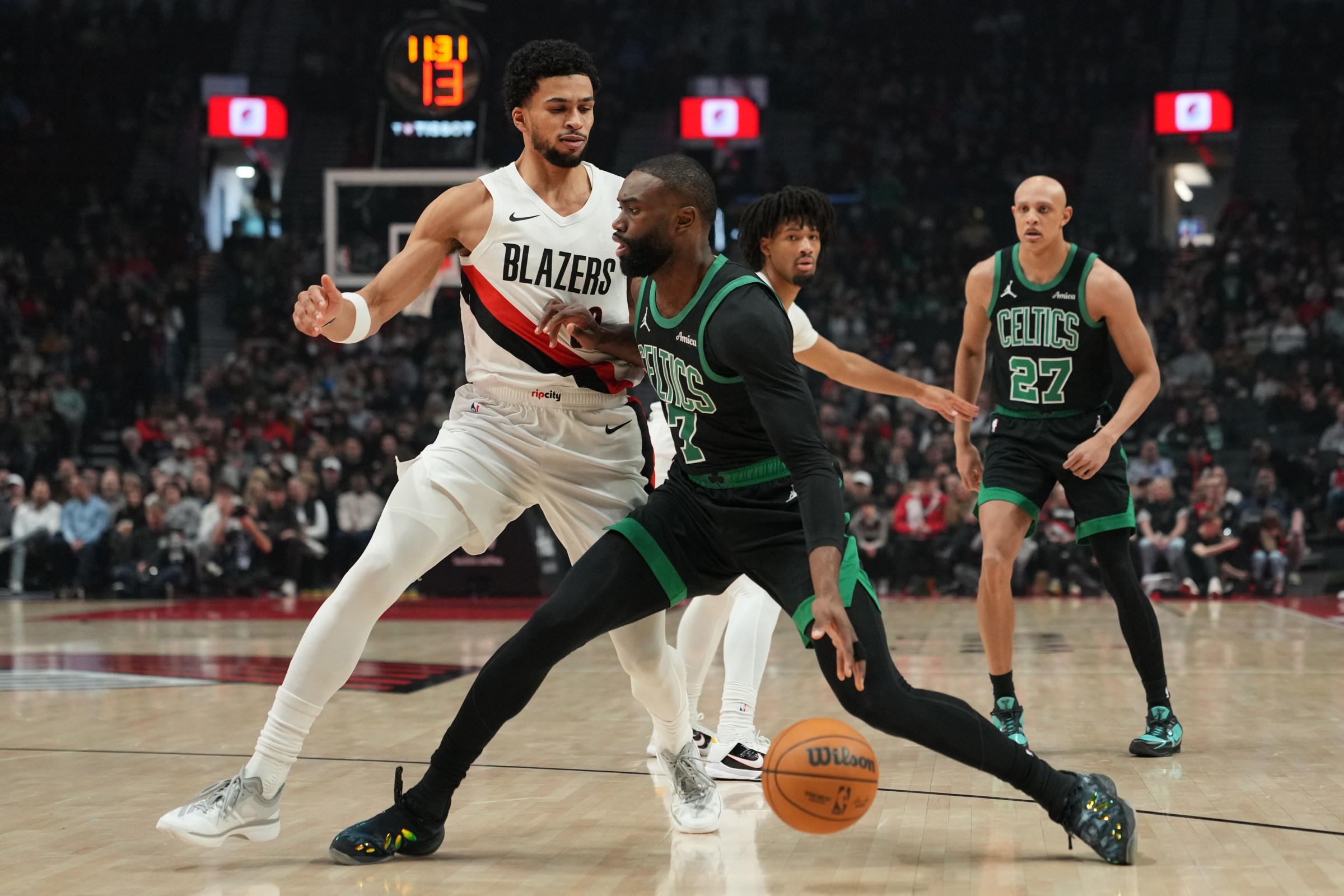 Dec 28, 2025; Portland, Oregon, USA; Boston Celtics guard Jaylen Brown (7) handles the ball against Portland Trail Blazers forward Toumani Camara (33) during the first half at Moda Center. Mandatory Credit: Soobum Im-Imagn Images