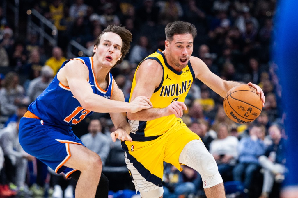 Indiana Pacers guard T.J. McConnell dribbles the ball while New York Knicks guard Tyler Kolek defends.