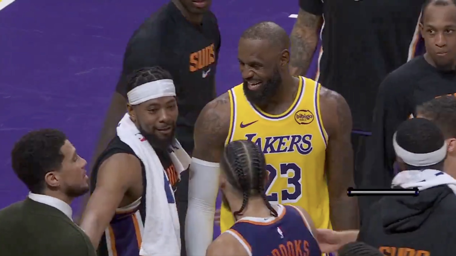 Lakers star LeBron James laughing with Suns players